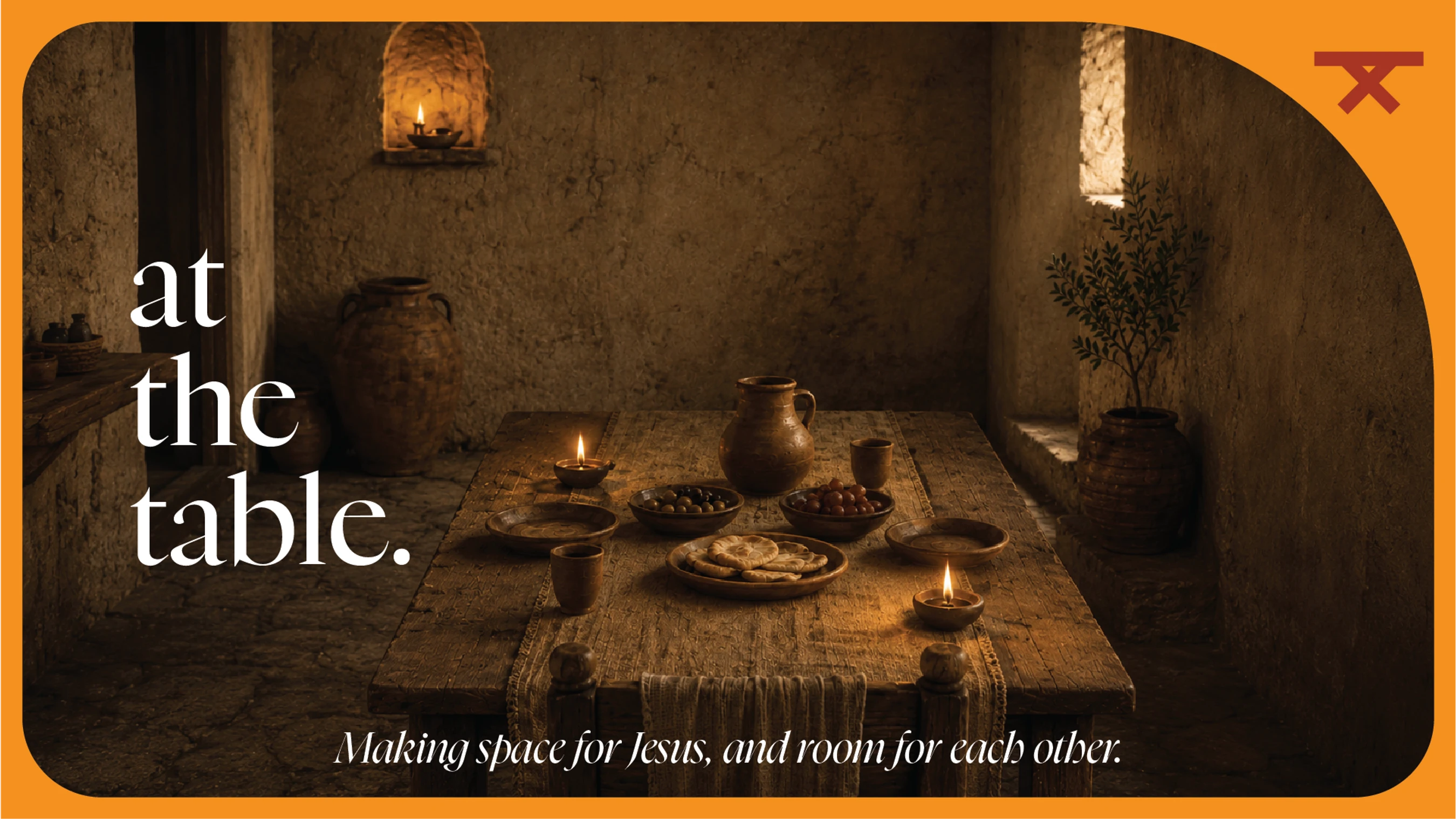 A rustic, candlelit table set for a meal in an ancient room. Text reads: 'at the table. Making space for Jesus, and room for each other.'
