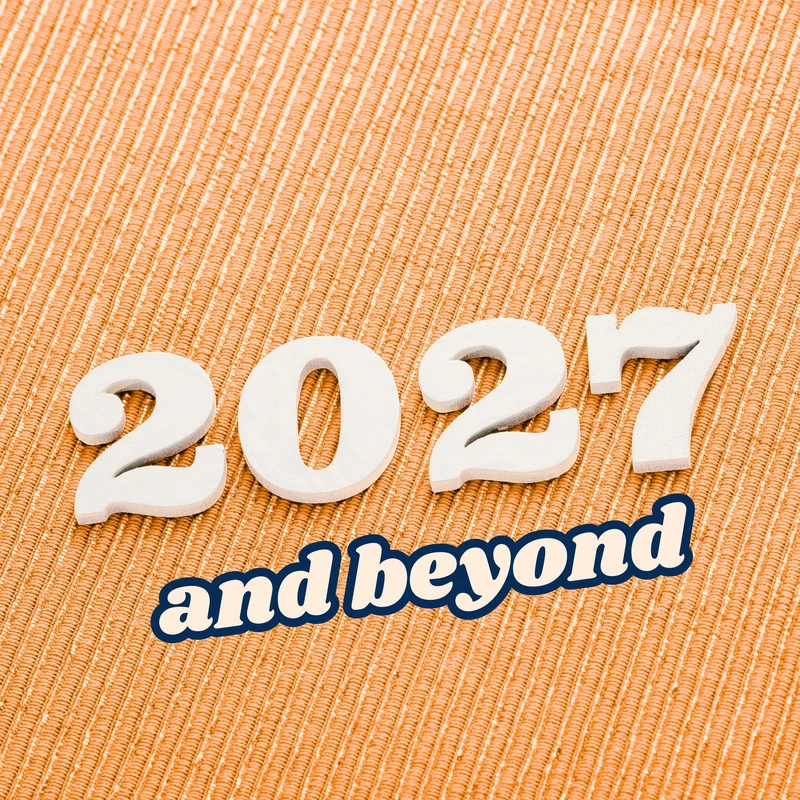 White 3D numbers forming the year 2027 with the text 'and beyond' below it, all set against a textured orange fabric background.