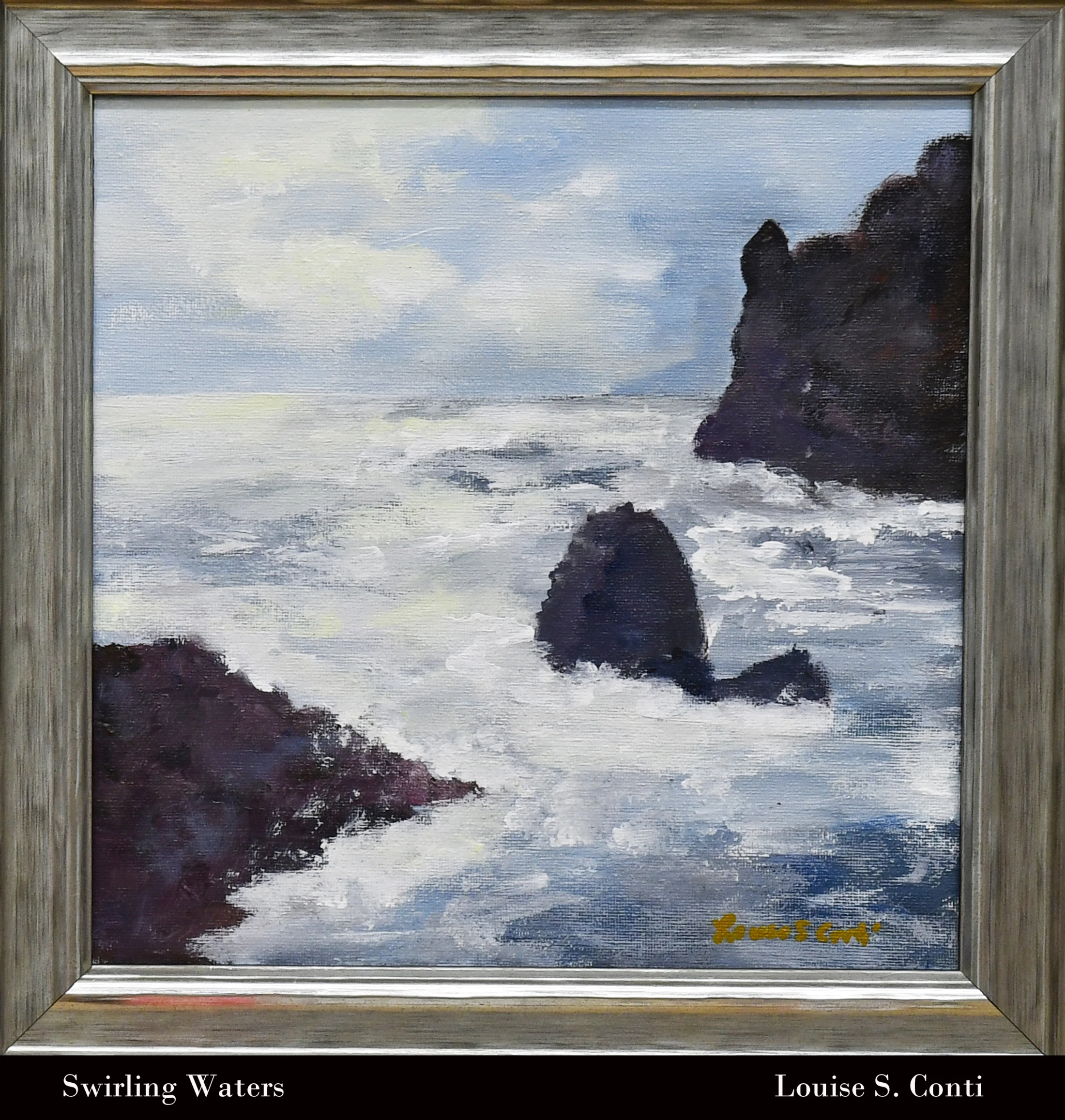A painting of a turbulent ocean with white water swirling around dark, jagged rocks under a cloudy blue sky. The artwork is in a silver-colored frame.