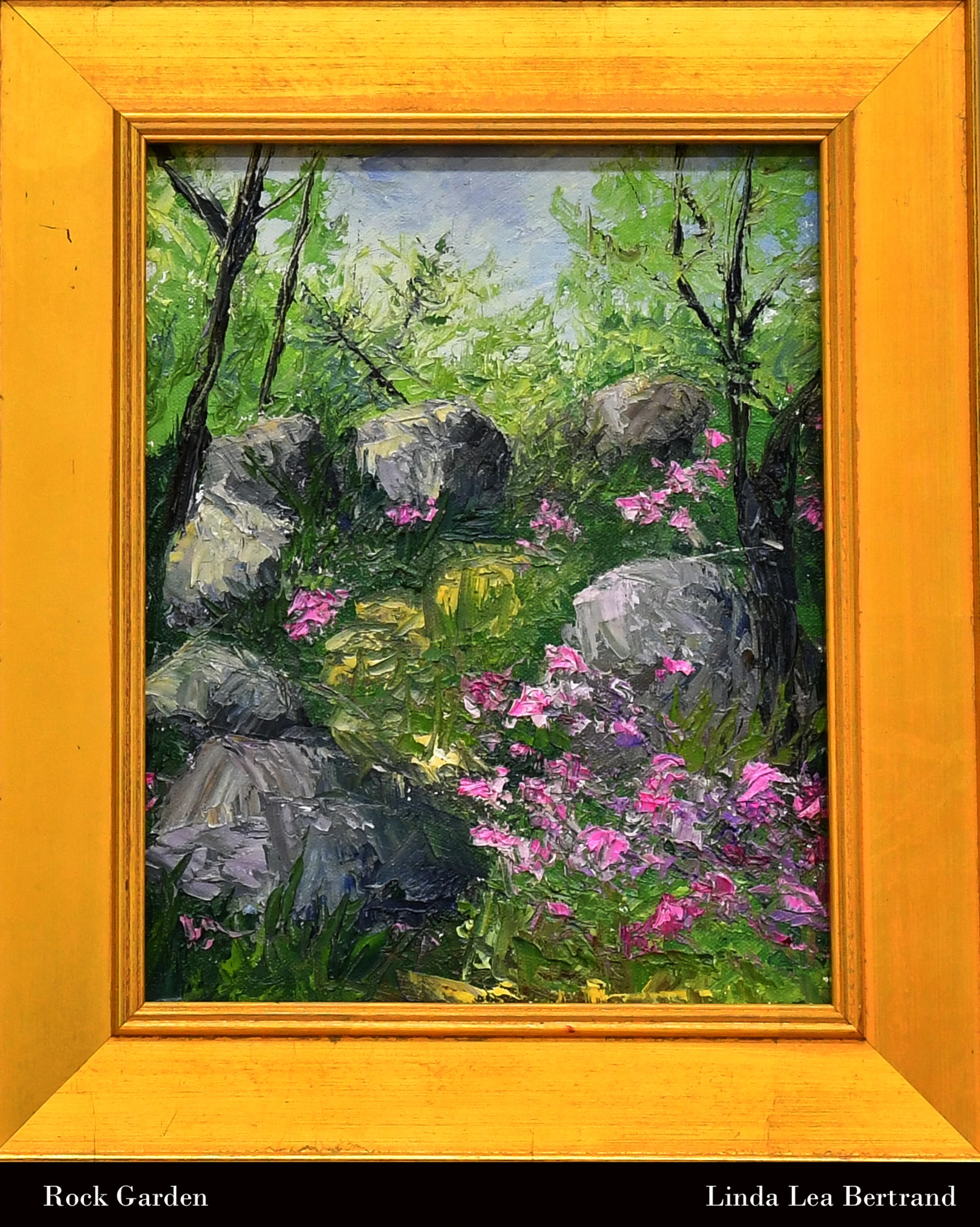 An impressionist oil painting of a lush rock garden with grey boulders, green foliage, and pink flowers, presented in a thick, bright yellow wooden frame.