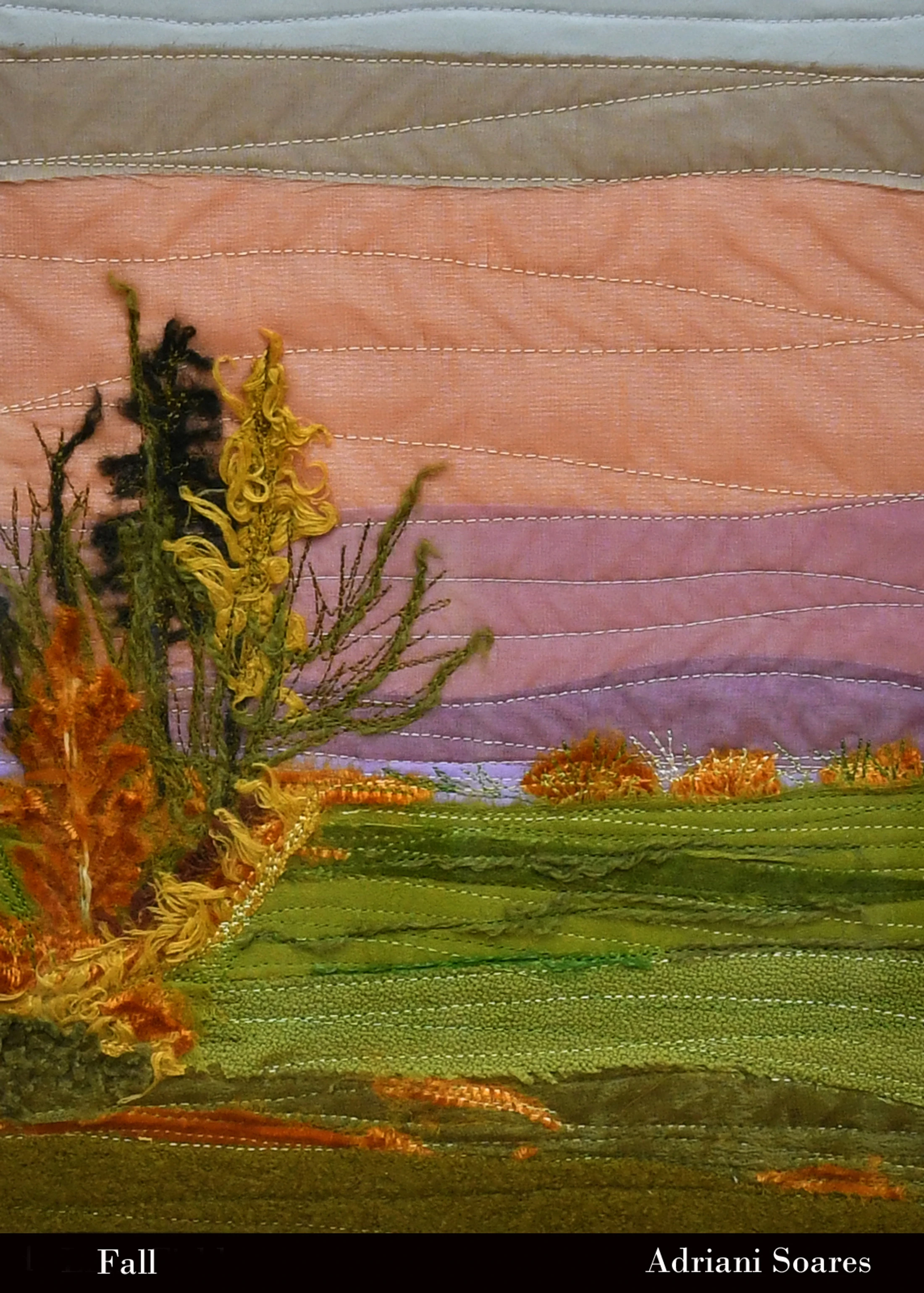 A textile art piece depicting an autumn landscape with textured trees and fields, created with quilting, varied fabrics, and colorful yarns.