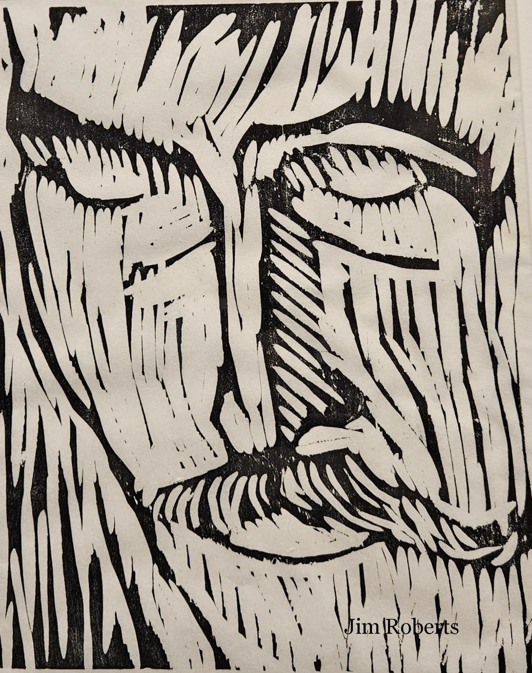 A black and white woodcut print showing a close-up of a man's weary face. He has a long beard and mustache, and his eyes are closed. By artist Jim Roberts.