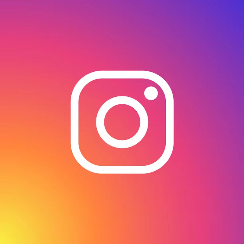 The Instagram logo, a white camera icon, on a vibrant orange, pink, and purple gradient background.