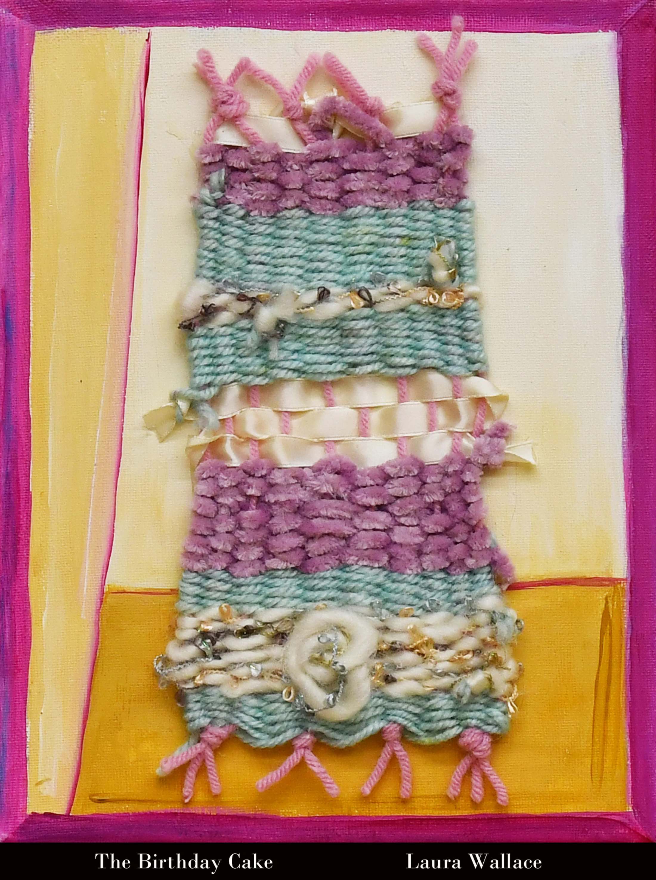 A small, textured weaving with pastel stripes of purple, green, and white, mounted on a painted canvas. The piece is framed in bright magenta.