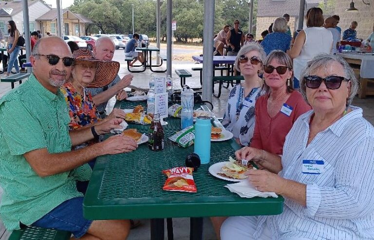Members of St. Mark sharing a meal and fellowship outdoors