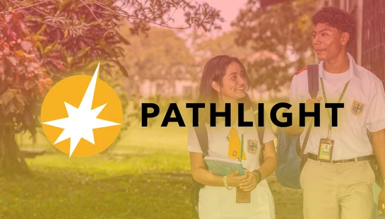 A male and female student in uniforms walk and smile at each other on a leafy campus, with the Pathlight logo and name overlaid on the image.