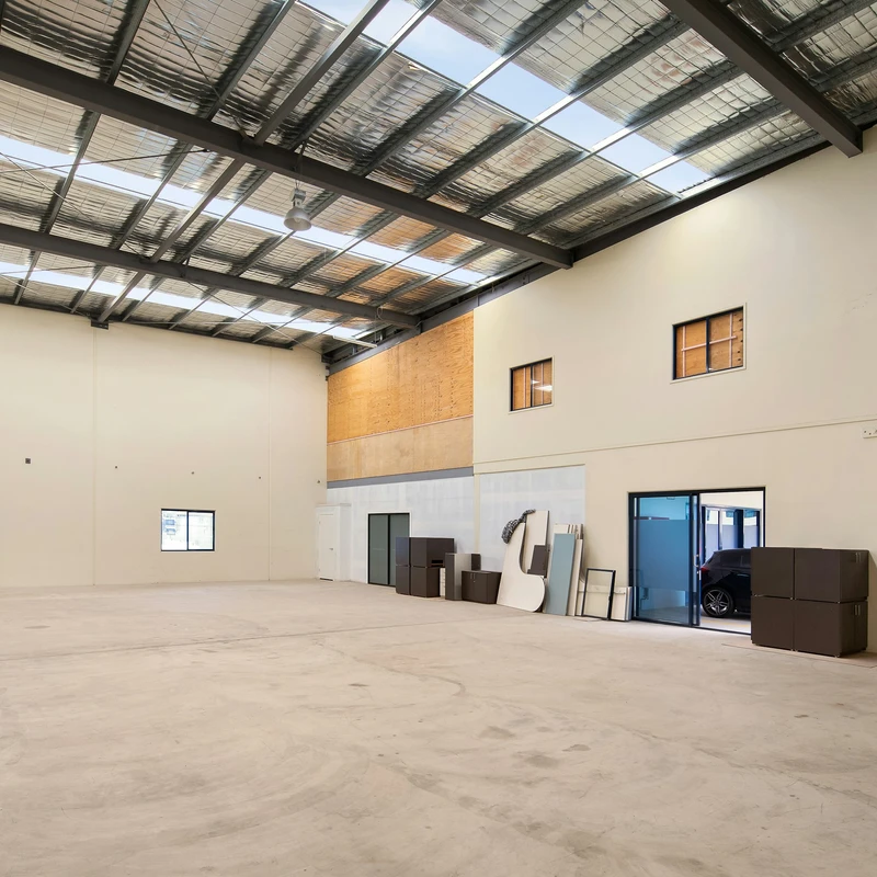 An empty warehouse with a door open