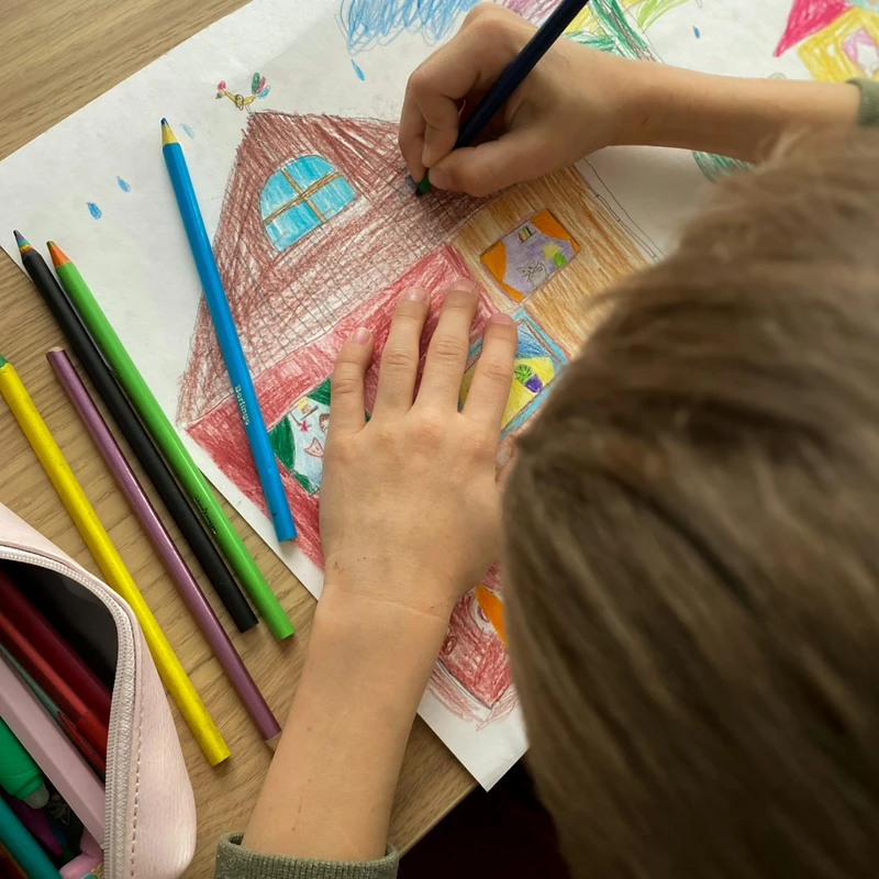 girl drawing on white paper