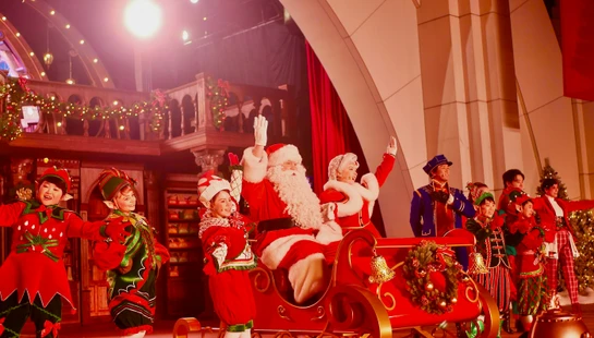 Santa claus and elves on a festive stage