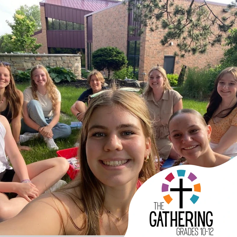A group of smiling high school students takes a selfie on a grassy lawn in front of a brick building. A logo for 'The Gathering Grades 10-12' is in the corner.