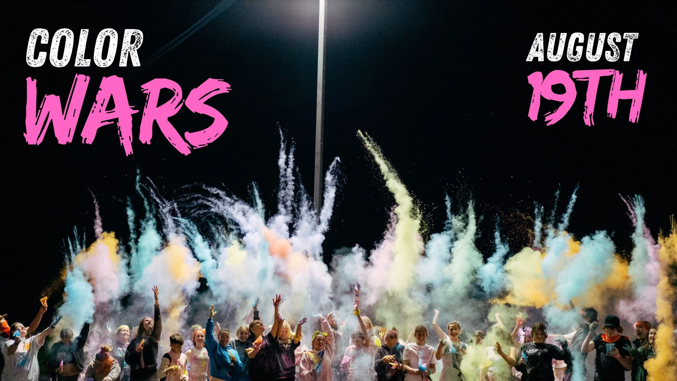 Promotional graphic for a 'Color Wars' event on August 19th. A crowd of people celebrate at night by throwing colorful powder into the dark sky.