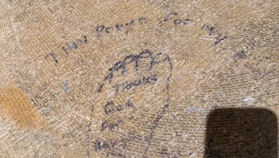A hand-drawn footprint on a textured stone surface with a prayer of thanks written inside and around it. The text mentions family and God.