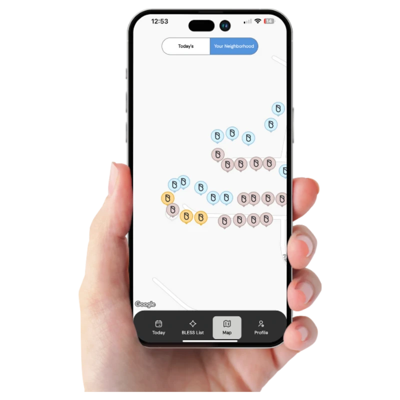 A person's hand holds a smartphone showing a map of a neighborhood. The map displays streets with many colorful pins, each marked with the letter 'B'.