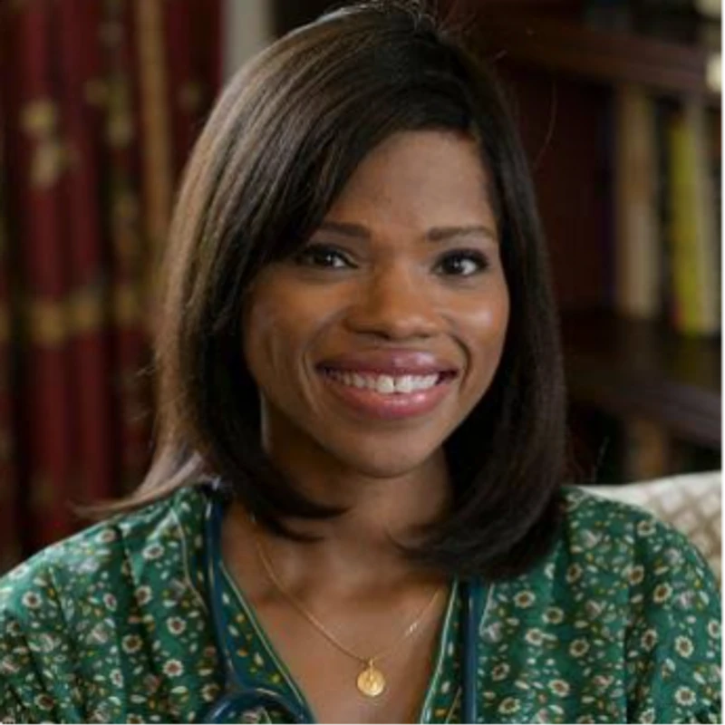 A headshot of a smiling Black woman with shoulder-length dark hair, wearing a green patterned shirt and a stethoscope around her neck.