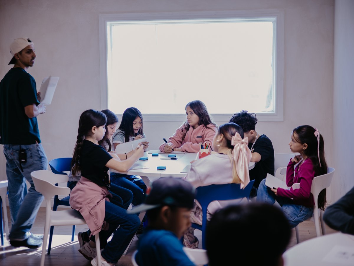 Oaks preteens gathered around a table for a small group discussion