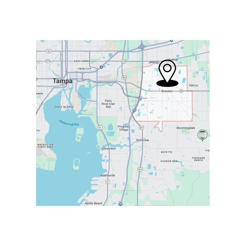 A digital map of the Tampa, Florida area. A red dotted line outlines the Brandon region, where a large black location pin is placed.