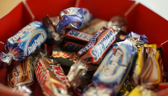assorted chocolate bar on red shelf