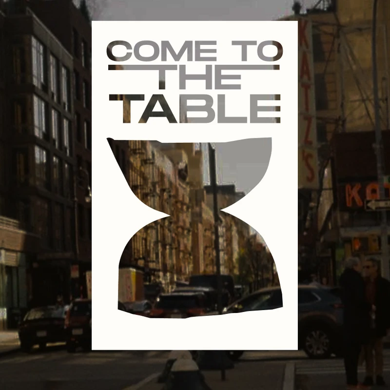 A graphic with the text 'Come to the Table' is overlaid on a photo of a busy street in New York City, with the famous Katz's Delicatessen sign visible.