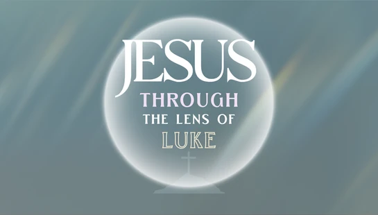 A graphic with the text 'Jesus Through the Lens of Luke' inside a glowing, lens-like circle. A faint cross on a hill is visible at the bottom.
