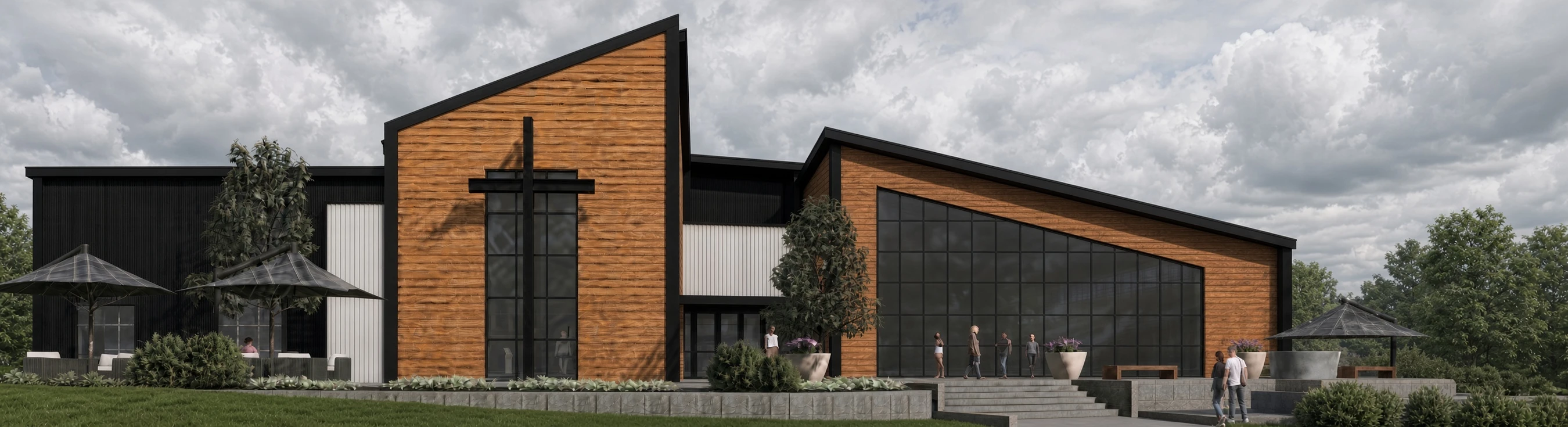 Exterior view of a modern church with angular roofs, wood and black metal siding, and a large cross. People are gathered on the steps and patio.