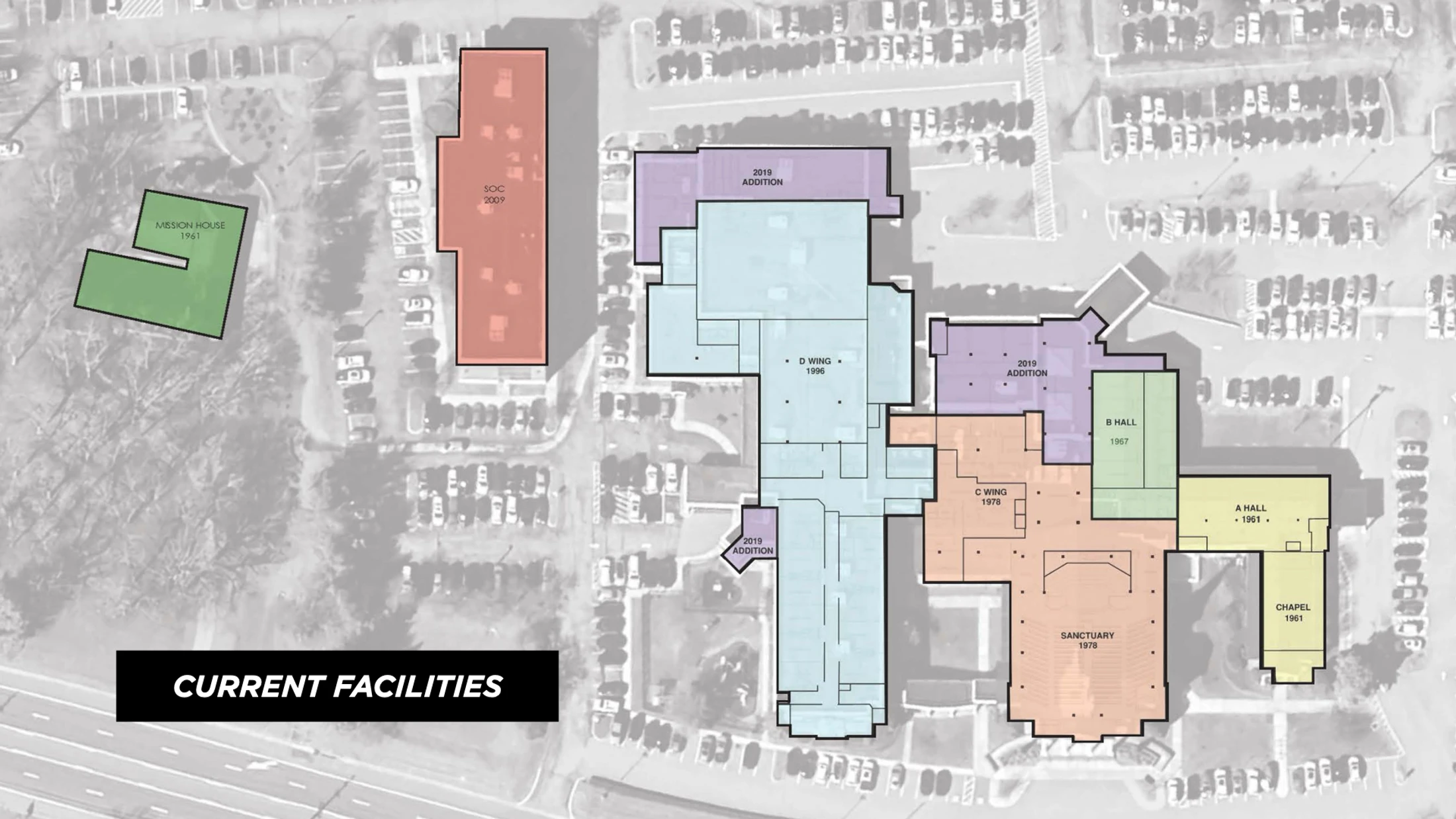An aerial map showing the layout of current facilities. Different buildings and wings are color-coded and labeled with their names and construction years.