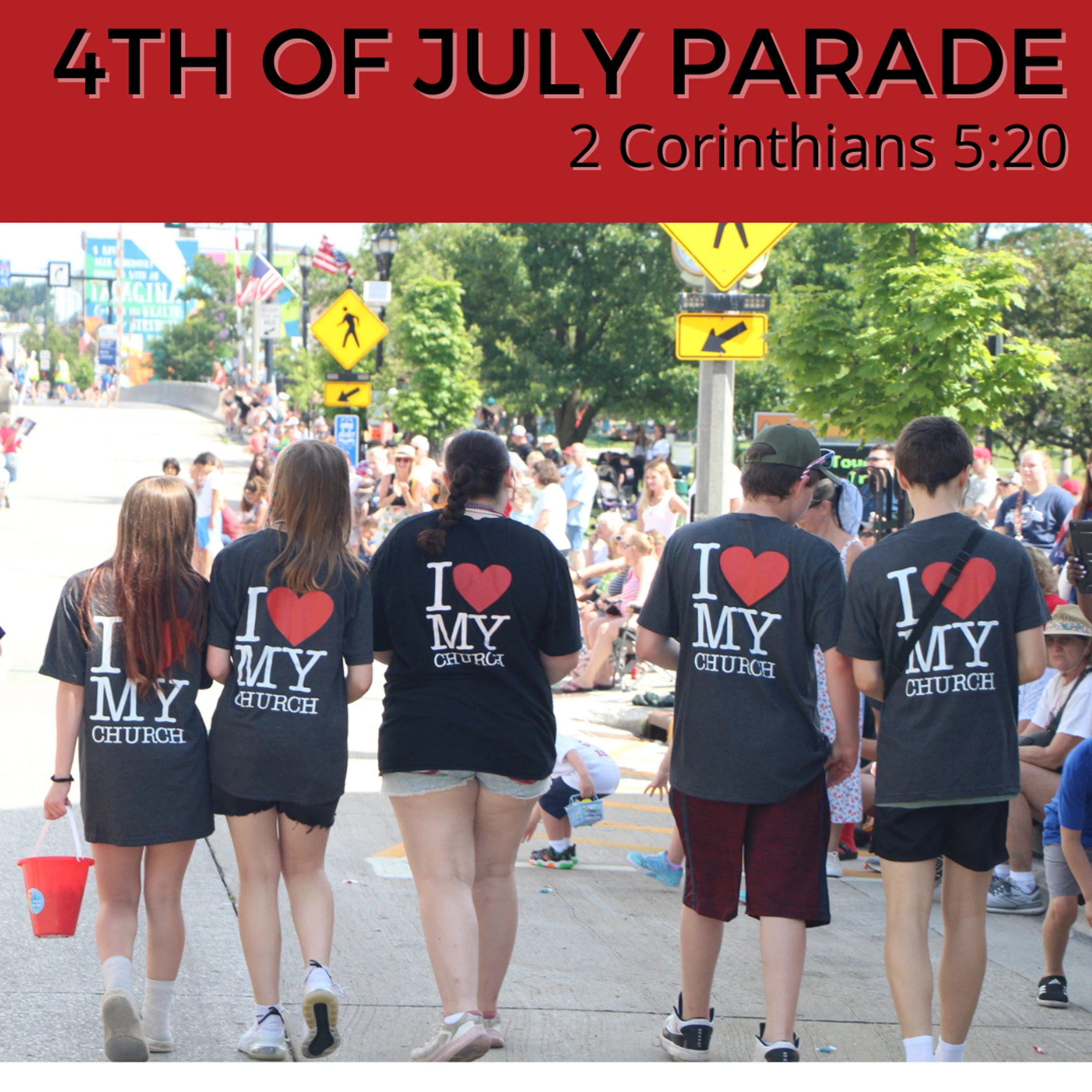 A group of young people seen from behind, wearing 'I love my church' t-shirts while walking down a street in a crowded Fourth of July parade.