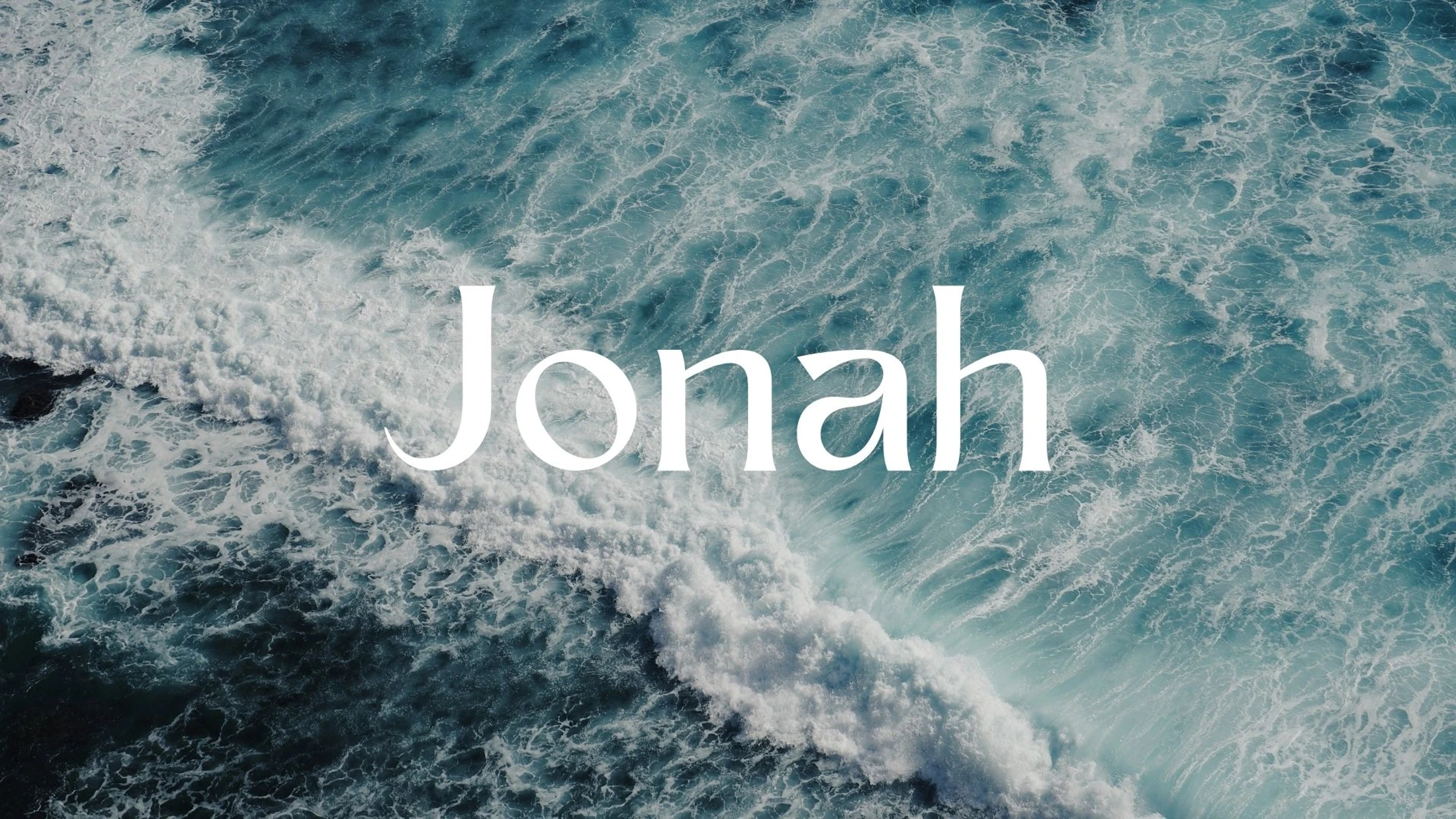 The word 'Jonah' in a white serif font is centered over an aerial photograph of turbulent, deep blue ocean waves with white foam.