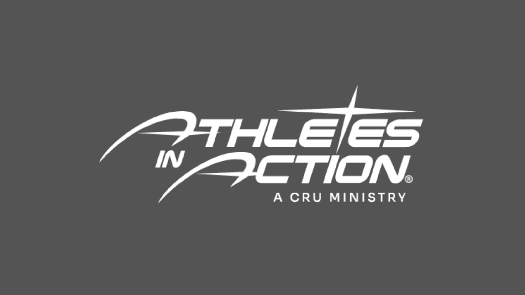 The white logo for Athletes in Action, a Cru Ministry. The logo uses a stylized, dynamic font on a solid gray background.