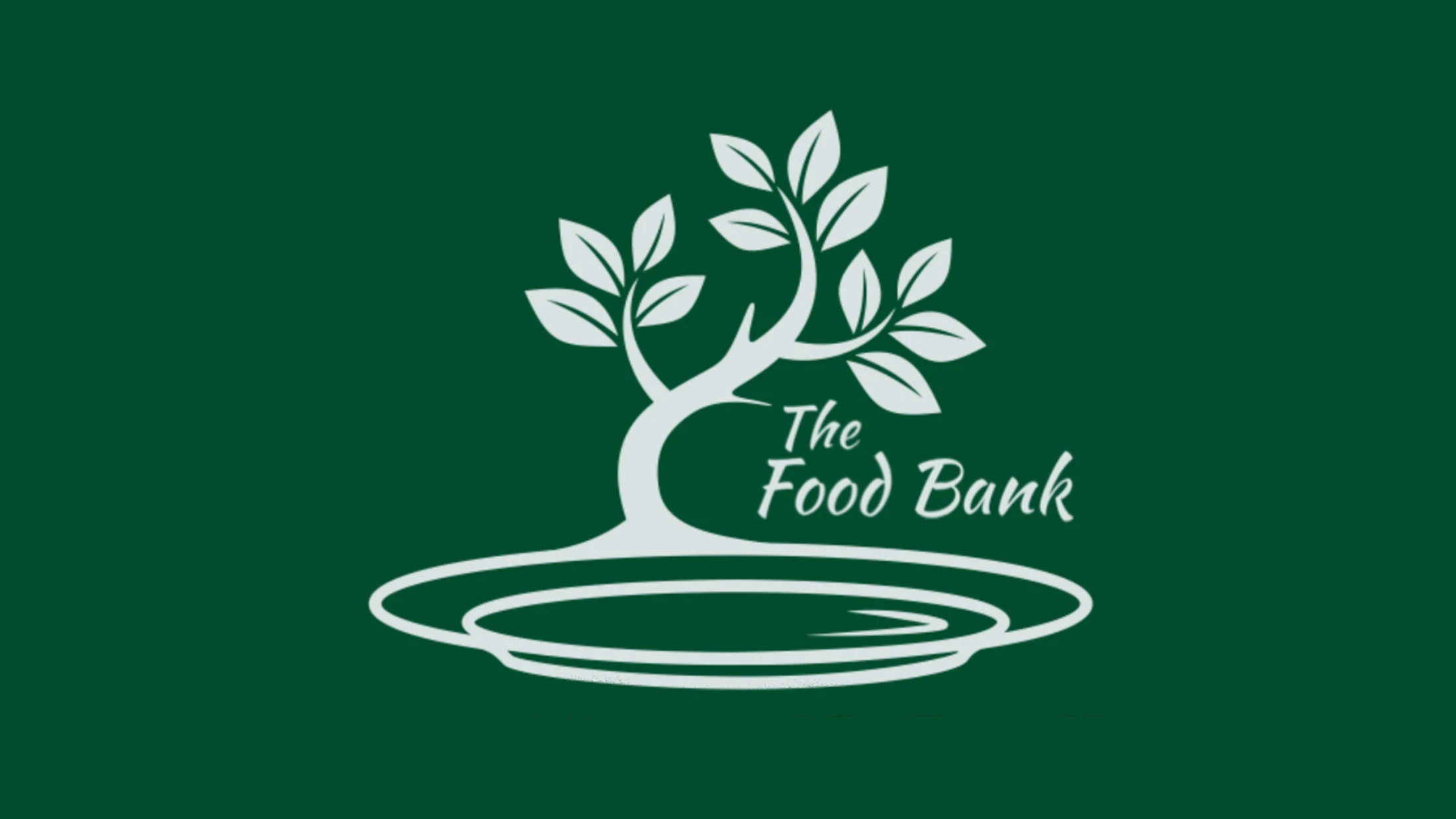 The logo for The Food Bank, showing a white tree with leaves growing out of a plate, set against a dark green background.