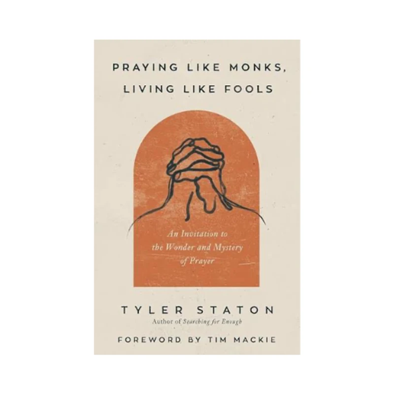 The book cover for "Praying Like Monks, Living Like Fools," featuring a line drawing of praying hands within an orange arched shape on an off-white background.