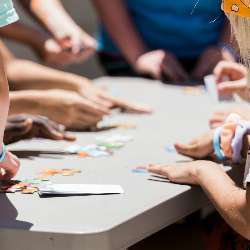 Children collaborate to assemble colorful puzzle pieces during a Kids Ministry activity at Redeemer Alliance Church, a Christian Church in Robbinsville, NJ.