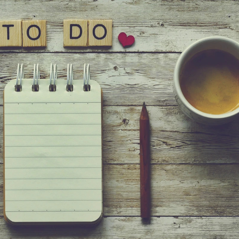 A notepad, coffee cup, and Scrabble tiles spelling "TO DO" with a red heart create a cozy vibe as you Plan Your First Visit to the Kids Ministry at Redeemer Alliance Church, a Christian Church in Robbinsville, NJ.