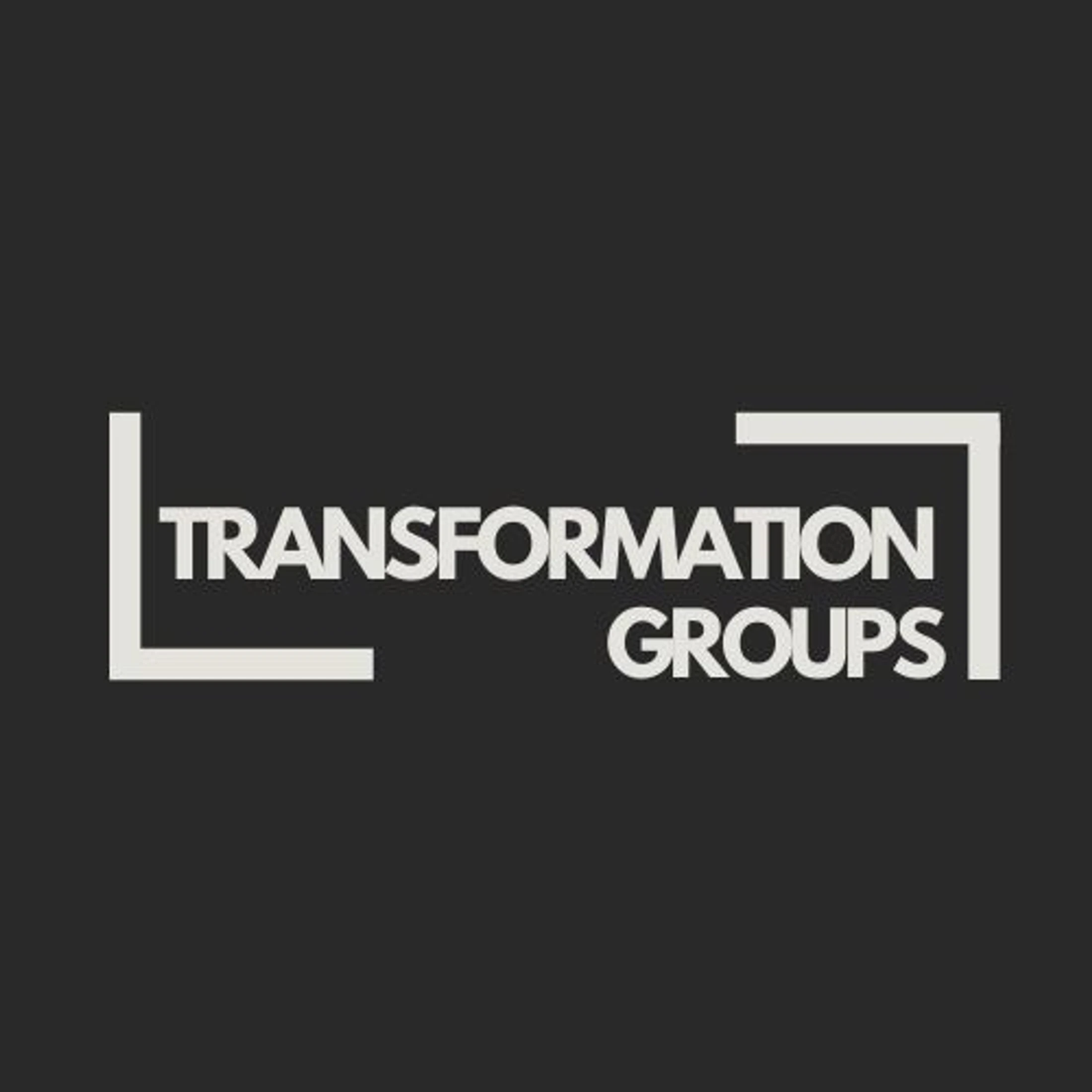 The logo for Transformation Groups, featuring off-white text in a modern font against a dark gray background, framed by two L-shaped brackets.