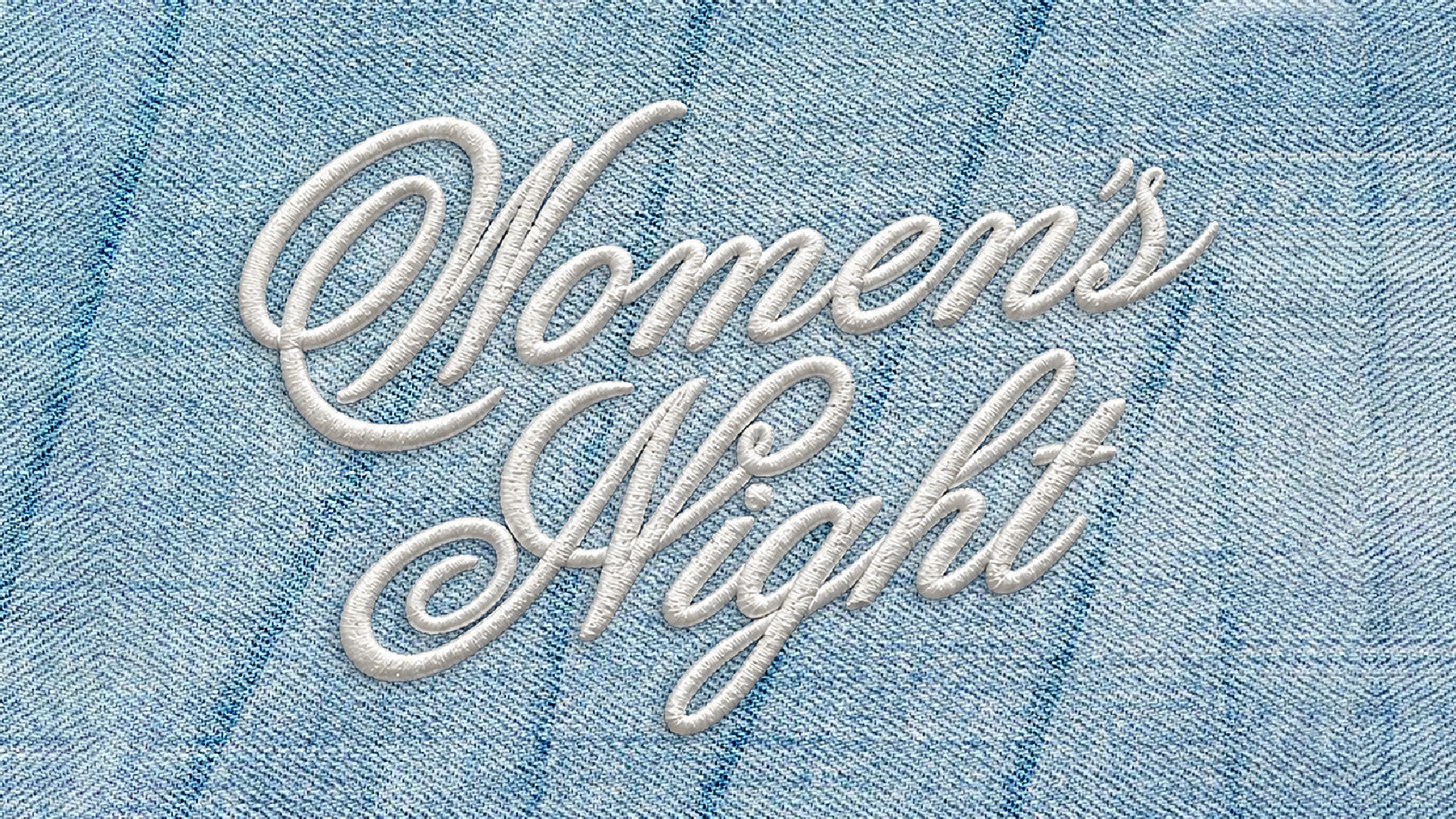 The words "Women's Night" embroidered in white cursive script on a light blue denim background. The stitching gives the text a 3D effect.
