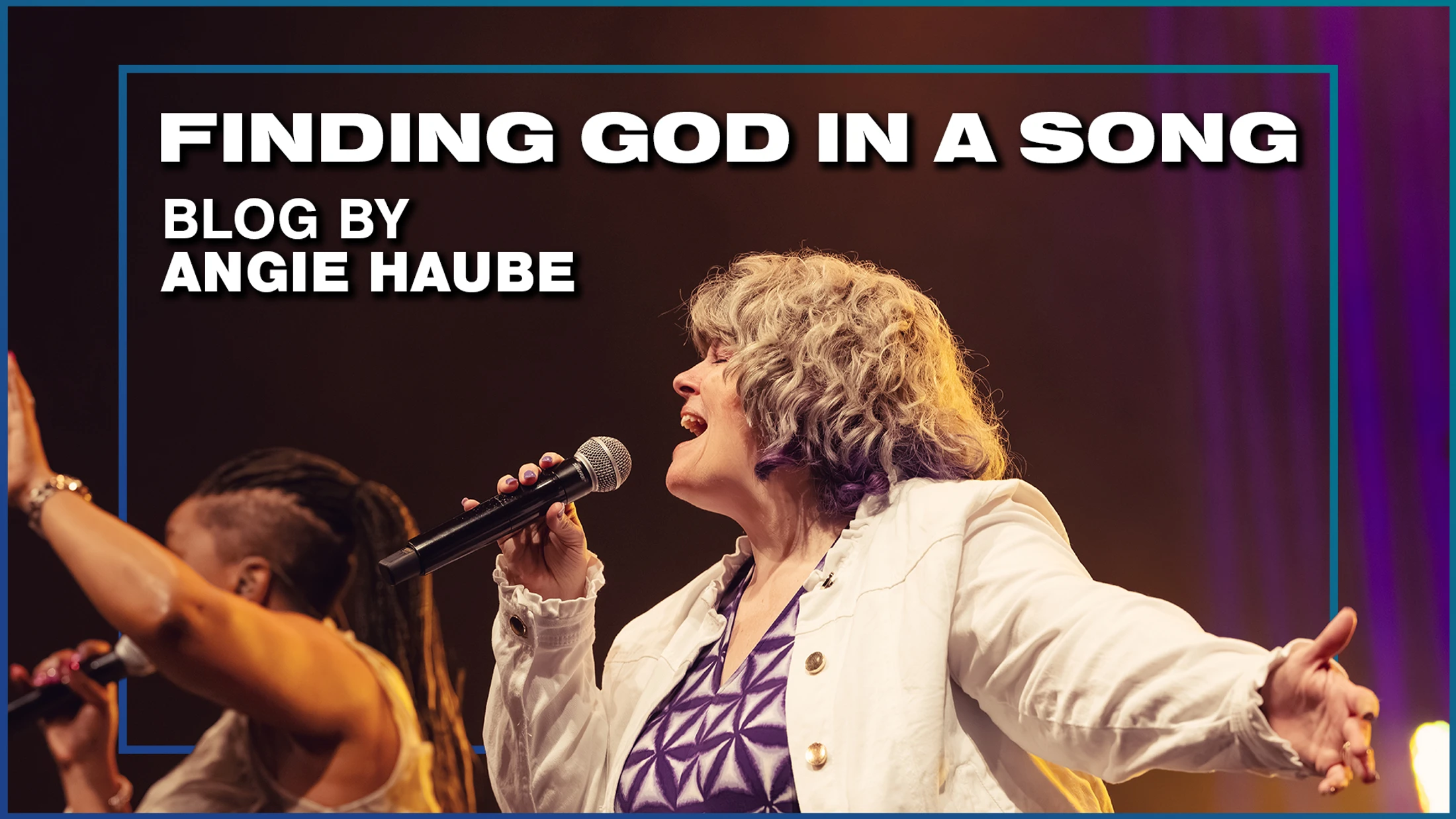 A woman with gray and purple hair sings into a microphone on stage. Text reads, "Finding God in a Song, Blog by Angie Haube."
