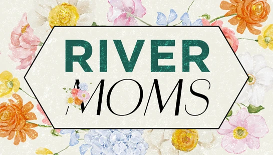 A banner with a watercolor floral background in pink, orange, and blue. In the center, a hexagon outlines the text "RIVER MOMS" in green and black fonts.