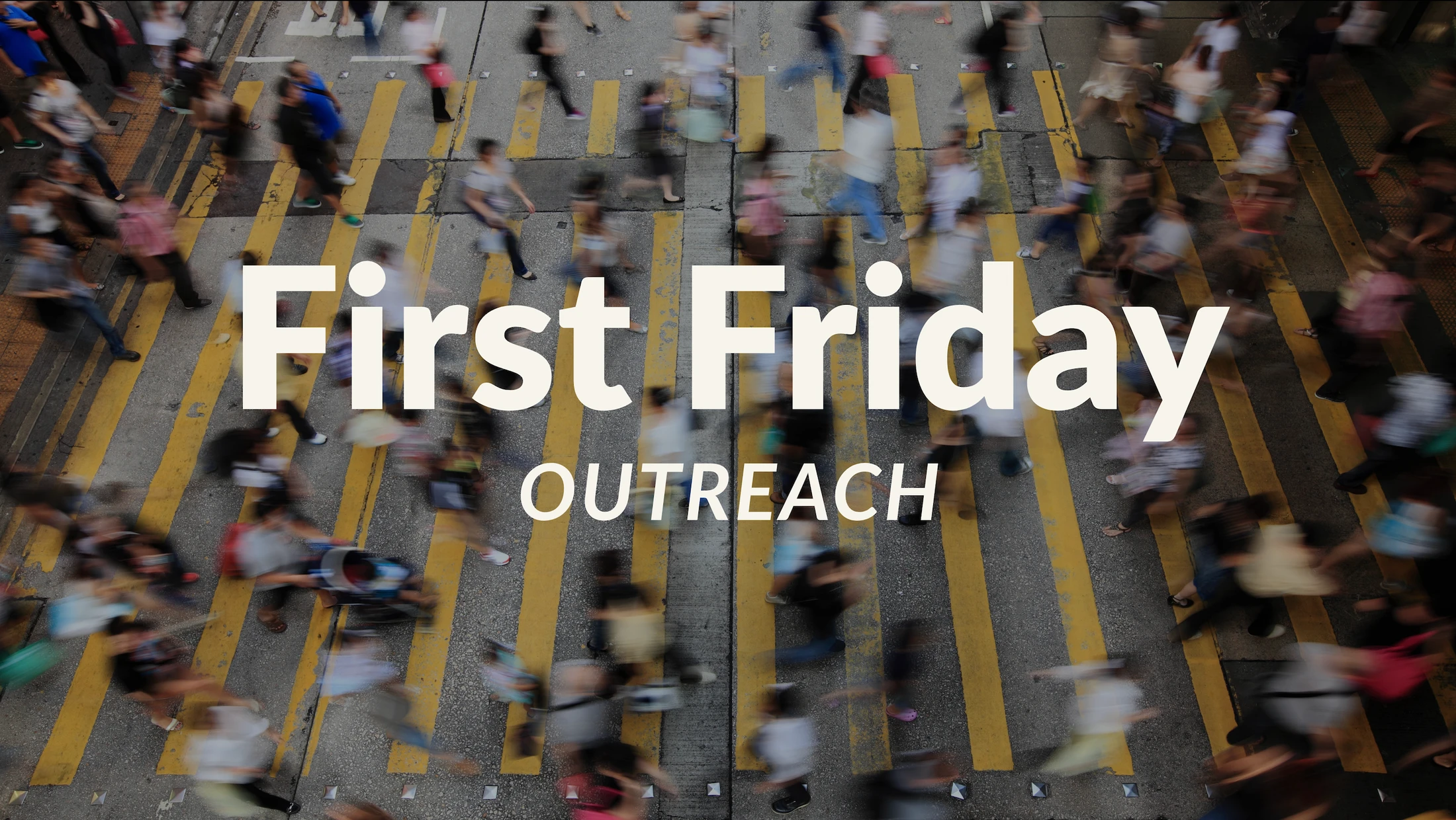 An overhead view of a busy crosswalk with blurred people walking. The text 'First Friday OUTREACH' is overlaid in the center.