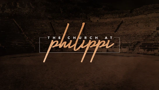 The text 'The Church at Philippi' in a glittery gold script, set against a dark, sepia-toned photo of an ancient stone amphitheater.