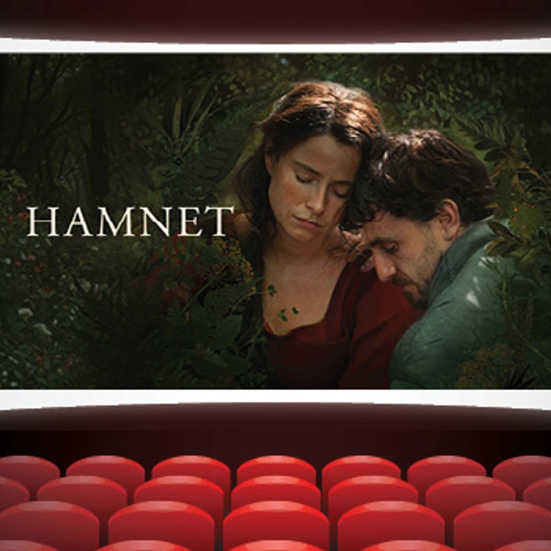 A movie poster for the film 'Hamnet' is shown on a large cinema screen, as seen from the perspective of an empty theater with red seats.