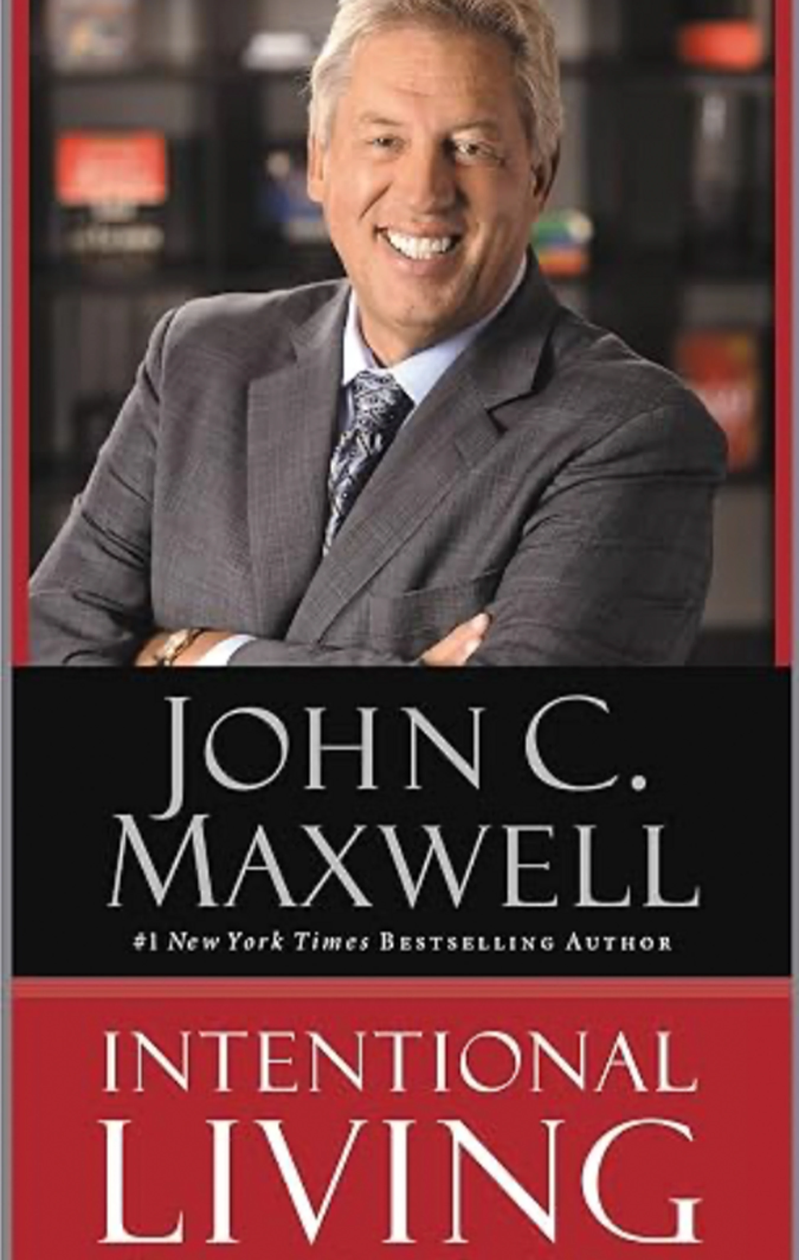 The book cover for 'Intentional Living' by John C. Maxwell, featuring a photo of the smiling author in a suit with his arms crossed.