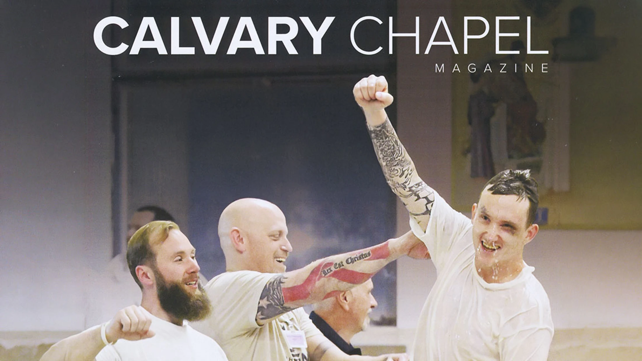 Cover of Calvary Chapel Magazine showing a joyful, wet man in a white shirt raising his fist in celebration after being baptized, supported by other men.