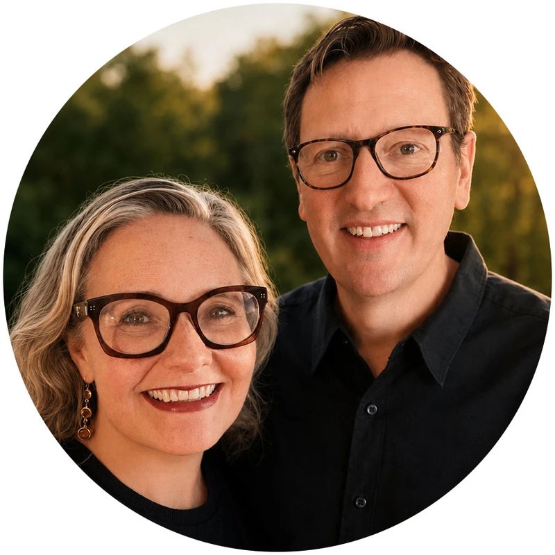 A circular, close-up portrait of a smiling woman with blonde hair and a man with brown hair. Both are wearing glasses and standing outdoors together.