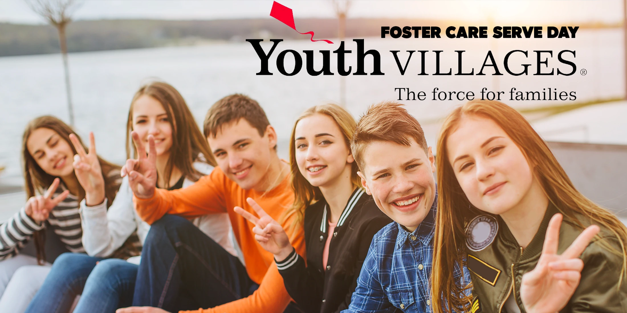 A group of happy teenagers smile and make peace signs for the camera. Text overlay reads "Foster Care Serve Day" and "Youth Villages, The force for families."
