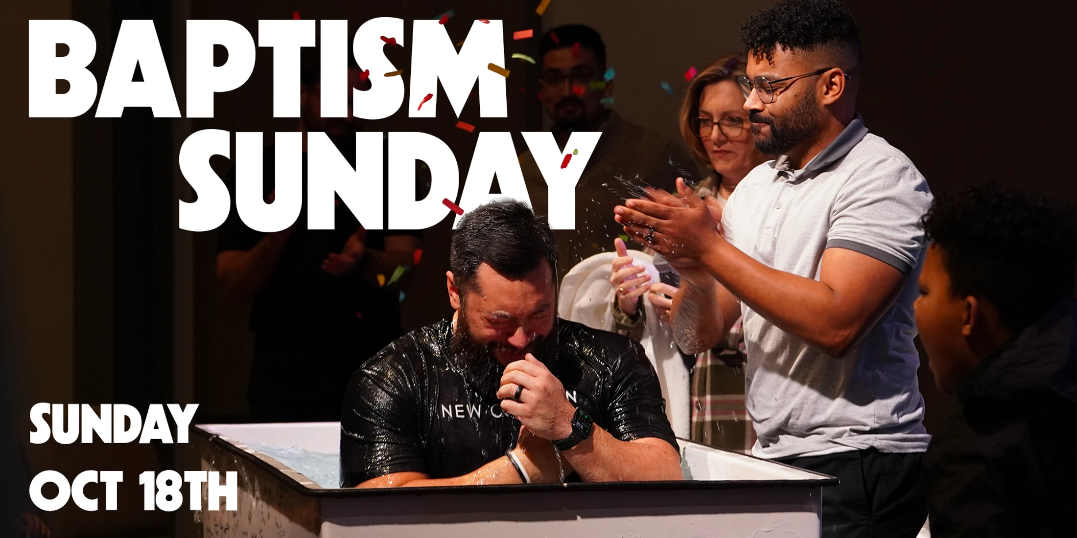 A man emerges from a baptismal tub, smiling joyfully as confetti falls and friends clap. The text reads 'Baptism Sunday' and 'Sunday Oct 18th'.