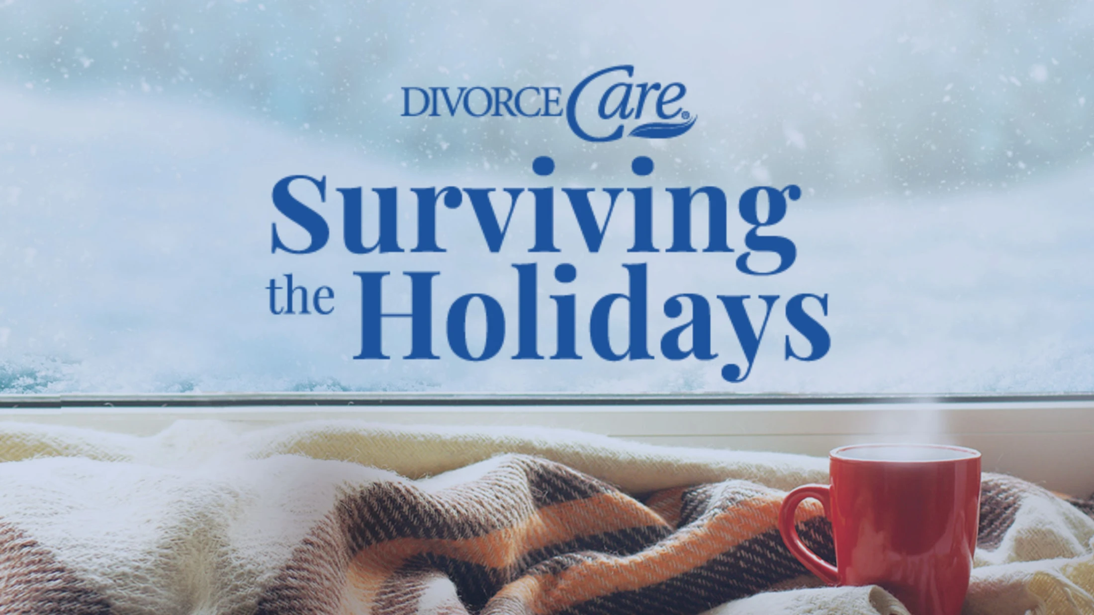 A red mug and cozy blanket sit by a window looking out at a snowy scene. Text overlay reads, "DivorceCare, Surviving the Holidays."