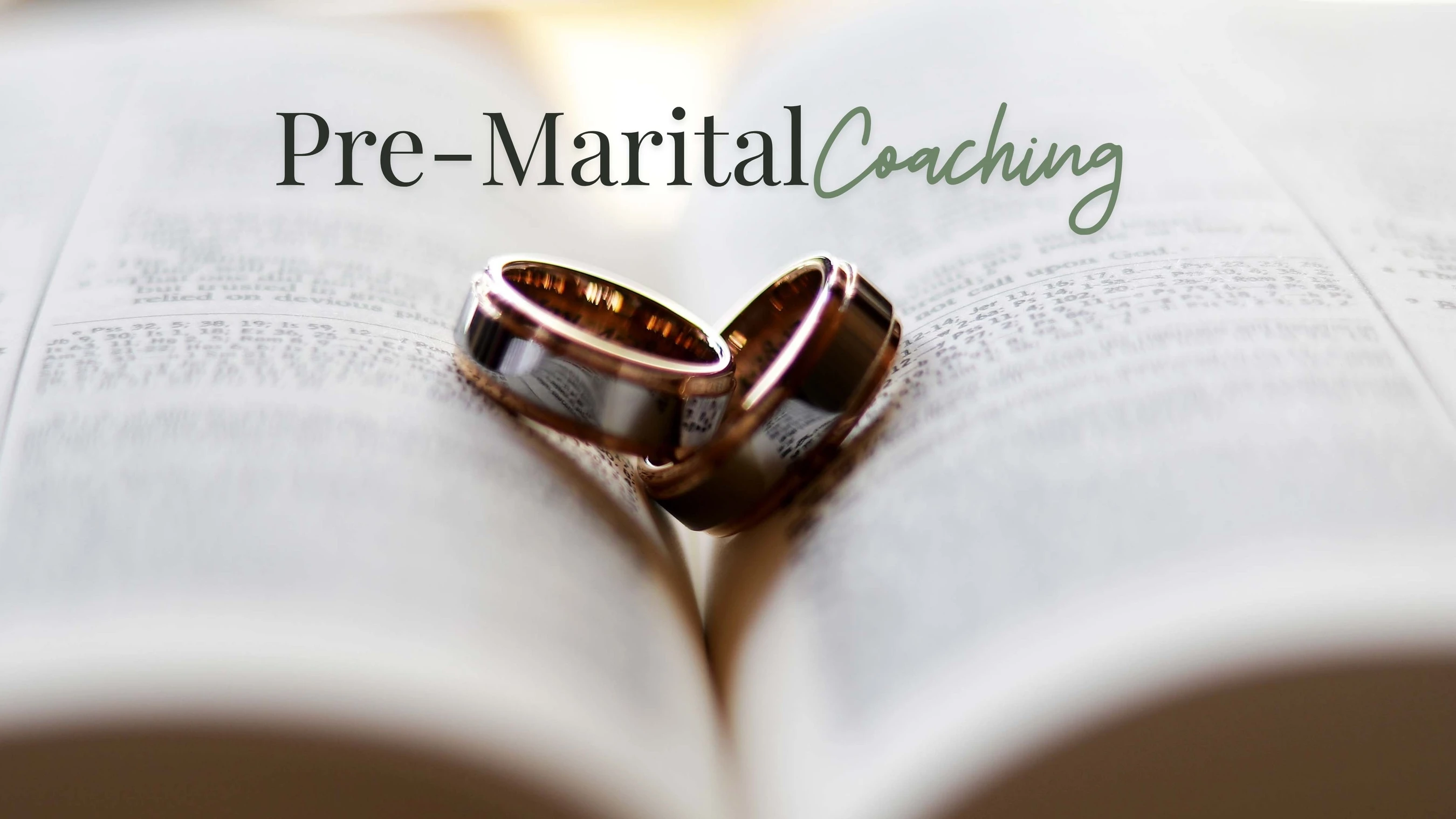 A pair of wedding rings rests in the center of an open Bible. The text 'Pre-Marital Coaching' is written over the image in black and green.